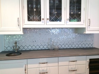 These small metallic tiles add just enough sparkle to a plain white kitchen. Courtesy of Wayne Tile.