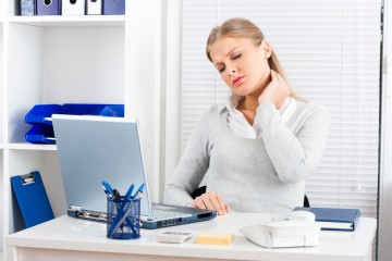 Woman Massaging Neck at desk