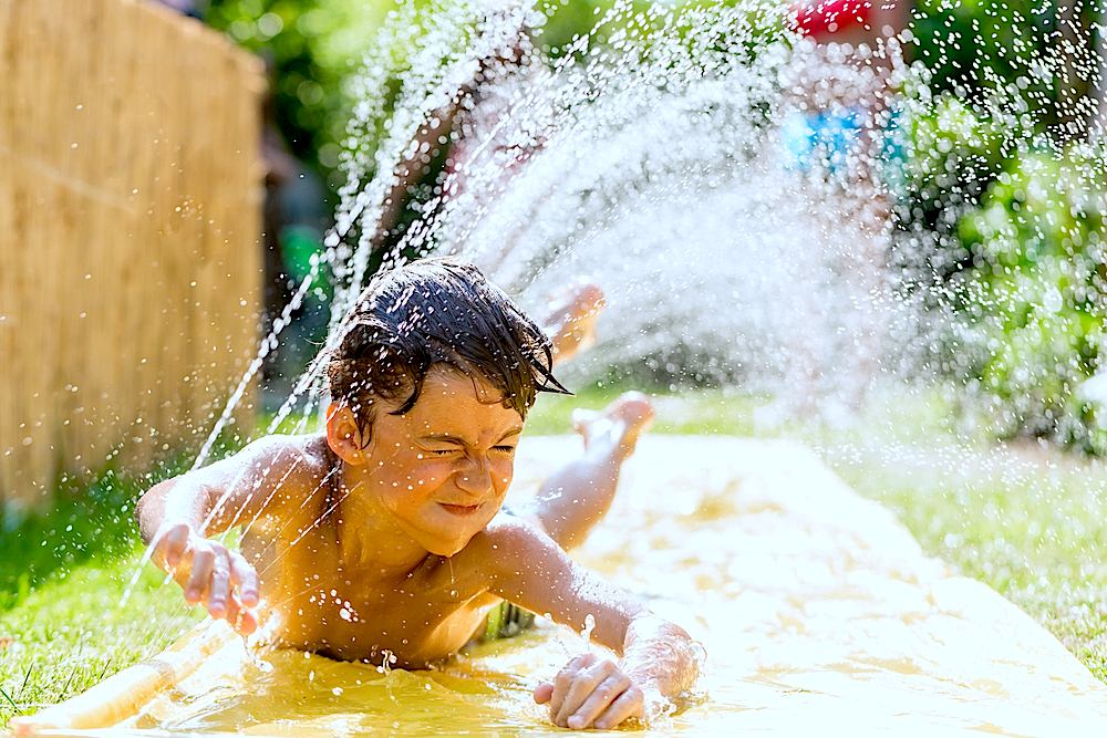 kid on waterside outside